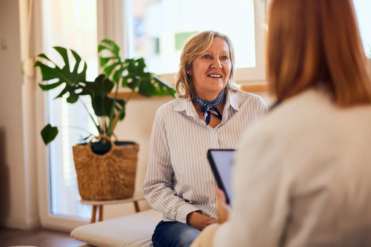 A woman in a supportive conversation with a counselor